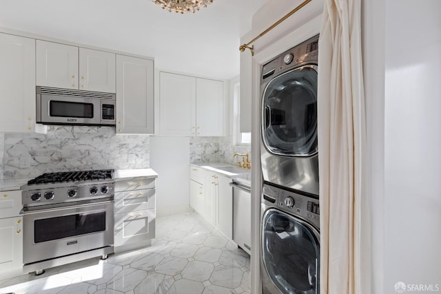 interior space with a sink, laundry area, and stacked washer / dryer