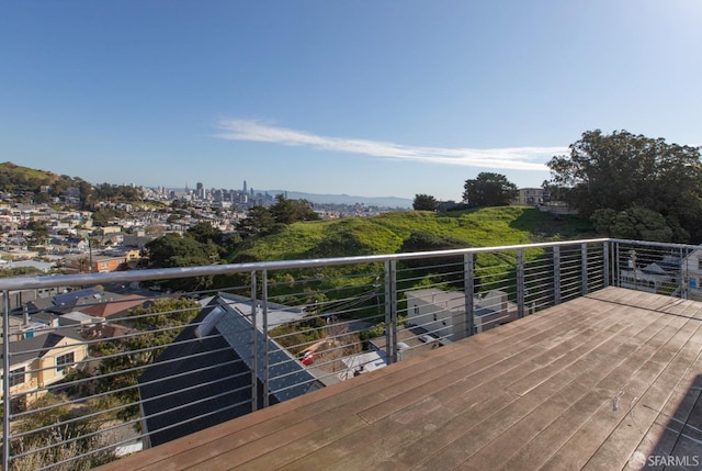 wooden terrace featuring a view of city