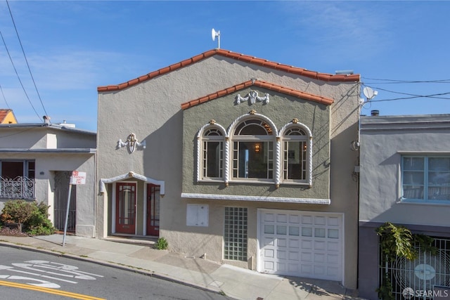 view of front of property featuring stucco siding and an attached garage