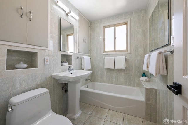 bathroom with tile walls, toilet, and tile patterned floors