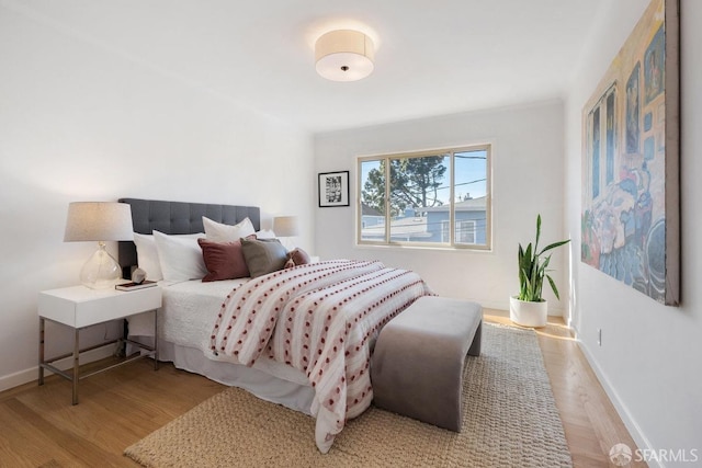 bedroom with wood finished floors and baseboards