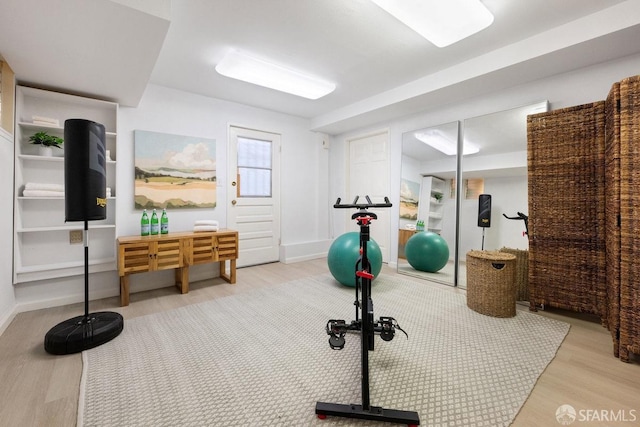 workout room featuring wood finished floors and baseboards