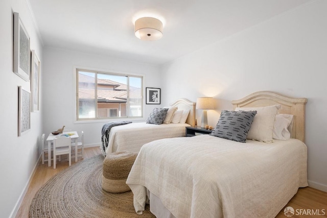 bedroom with light wood-style floors and baseboards