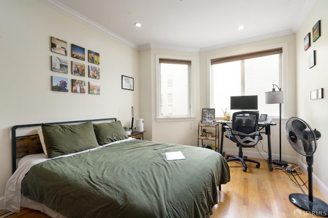 bedroom featuring ornamental molding and light hardwood / wood-style flooring