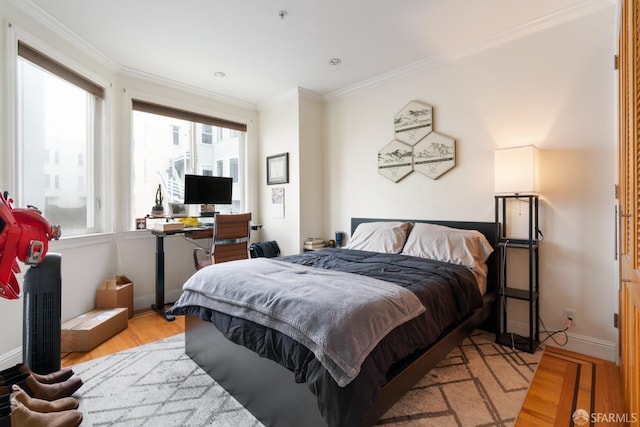 bedroom featuring ornamental molding and light wood-type flooring