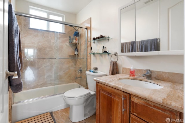 full bathroom with vanity, bath / shower combo with glass door, and toilet