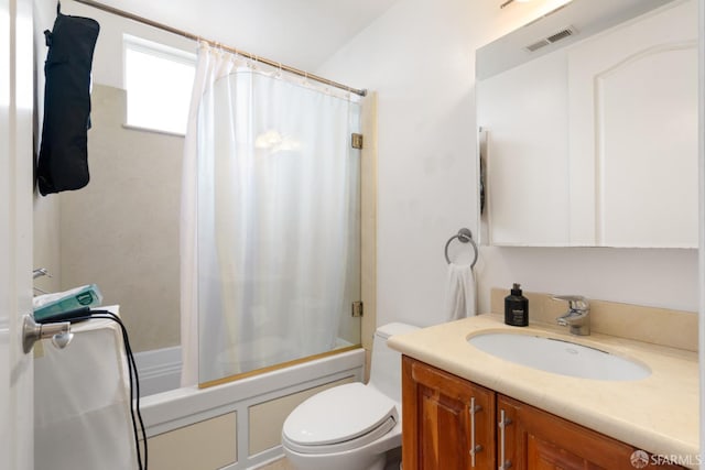 full bathroom featuring shower / tub combo with curtain, vanity, and toilet