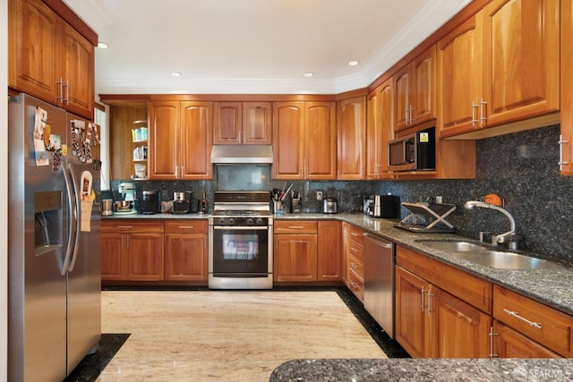 kitchen with backsplash, stainless steel appliances, sink, and dark stone counters