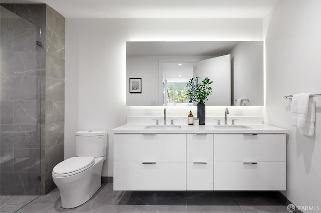 full bath featuring a sink, toilet, a stall shower, and double vanity