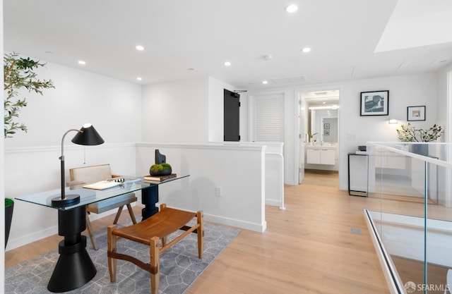 office area with recessed lighting, baseboards, and light wood finished floors