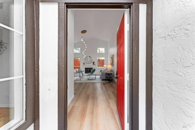 hallway featuring a textured wall and wood finished floors