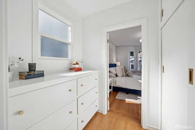 bedroom featuring multiple windows and light wood-type flooring