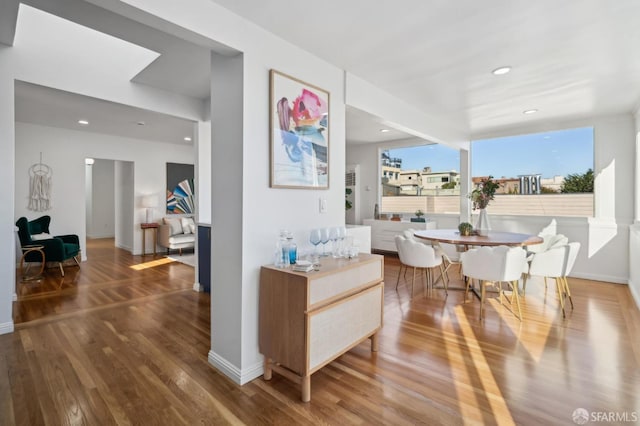 dining space with hardwood / wood-style floors