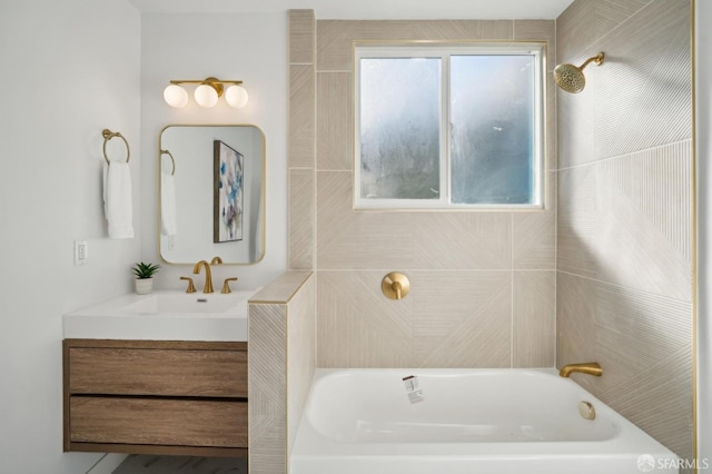 bathroom with vanity and tiled shower / bath