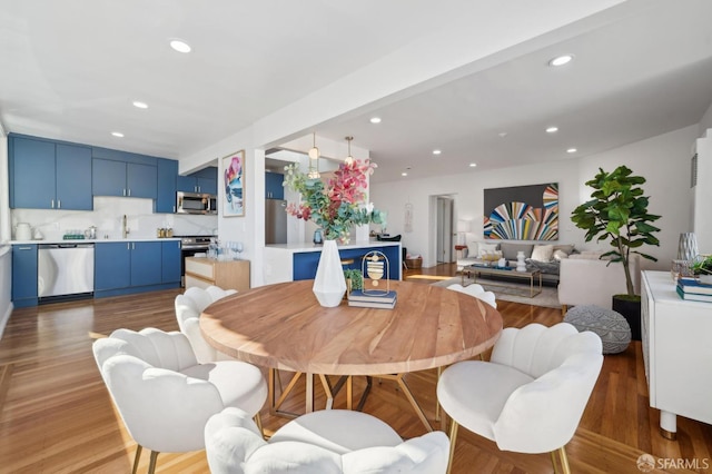 dining room with sink and hardwood / wood-style flooring