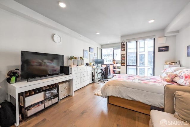 bedroom with light wood-style floors and recessed lighting