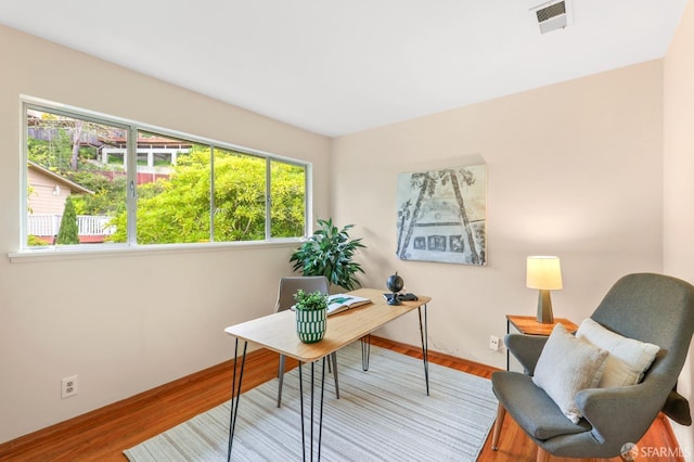 home office with visible vents and wood finished floors