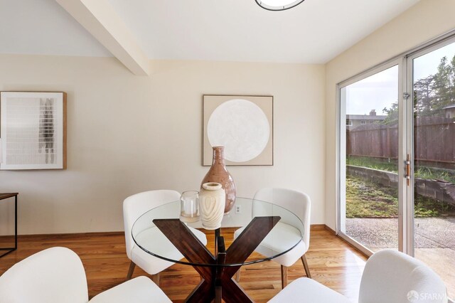 dining space featuring baseboards and wood finished floors