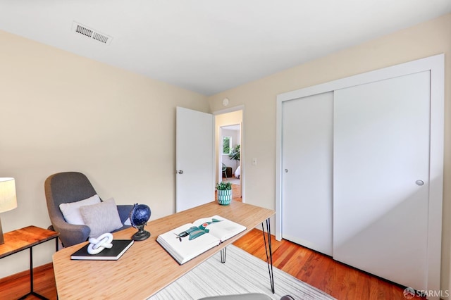 office space with visible vents and wood finished floors