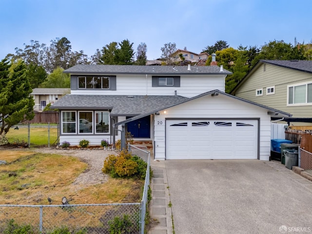 traditional-style home featuring fence, a shingled roof, aphalt driveway, a garage, and a sunroom