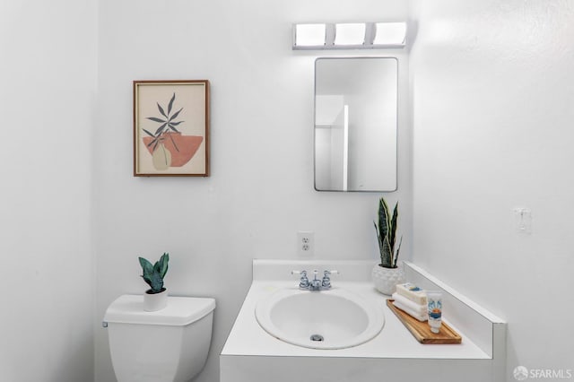 bathroom featuring toilet and vanity