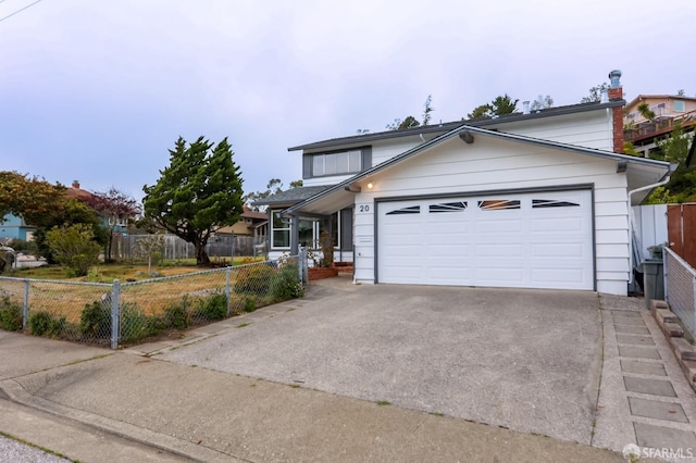 traditional home featuring fence, an attached garage, and driveway