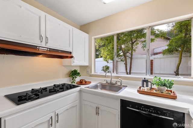kitchen featuring a sink, light countertops, white cabinets, and black appliances