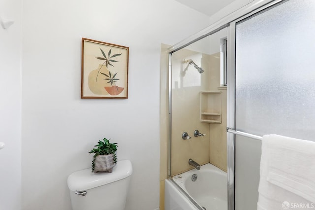 full bathroom featuring combined bath / shower with glass door and toilet