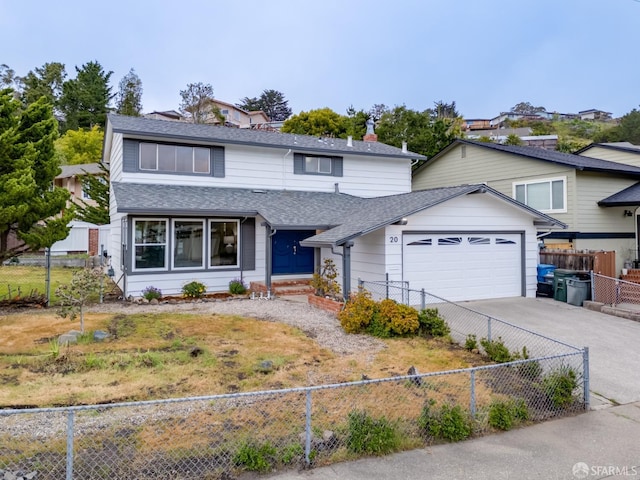 traditional-style house with roof with shingles, fence private yard, an attached garage, and driveway