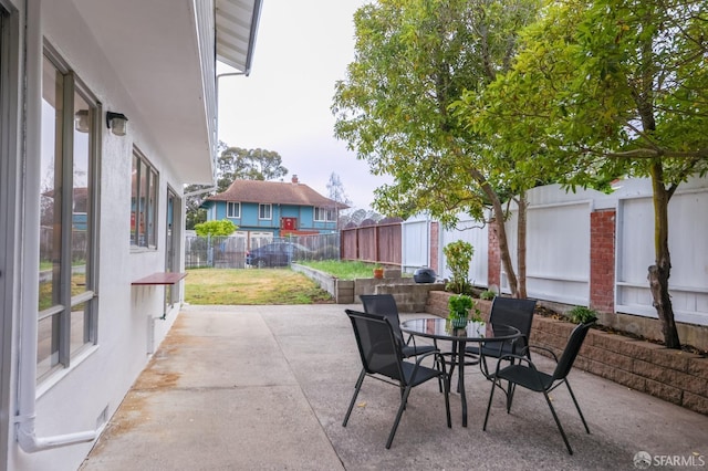 view of patio with outdoor dining area and a fenced backyard