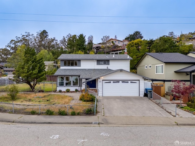view of front of property featuring fence private yard, an attached garage, roof with shingles, and driveway