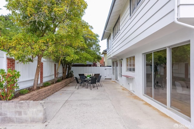 view of patio with outdoor dining area and a fenced backyard