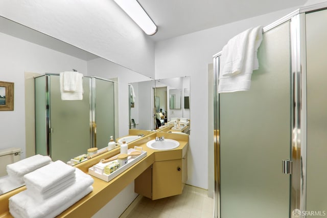 full bath featuring vanity, tile patterned floors, and a shower stall