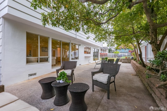 view of patio featuring fence and outdoor dining space