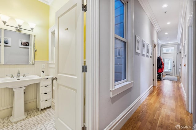 bathroom featuring ornamental molding and wood-type flooring