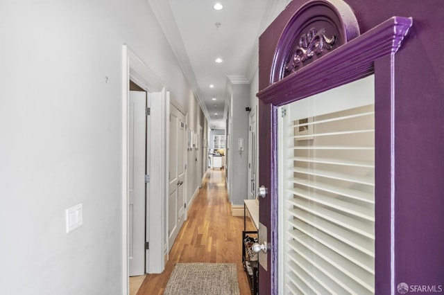 corridor with crown molding and light hardwood / wood-style flooring