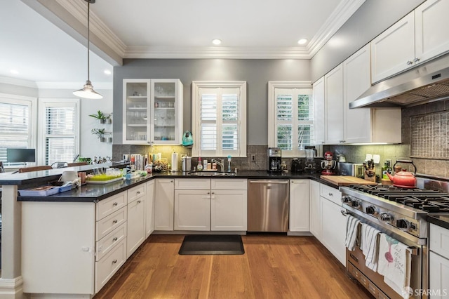 kitchen with pendant lighting, stainless steel appliances, and white cabinets