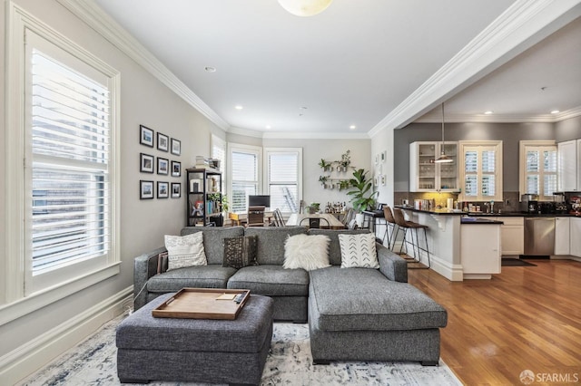 living room with hardwood / wood-style flooring and crown molding