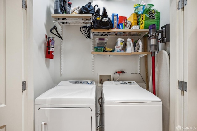 clothes washing area with washing machine and clothes dryer