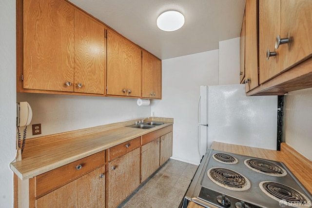 1455 Laguna St Unit 6, San Francisco, CA 94115 - kitchen featuring range, freestanding refrigerator, a sink, light countertops, and brown cabinetry