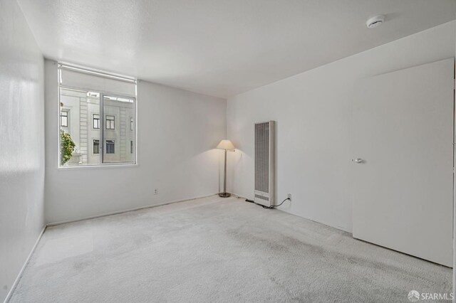 1455 Laguna St Unit 6, San Francisco, CA 94115 - spare room with a heating unit, carpet floors, and a smoke detector