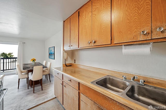 1455 Laguna St Unit 6, San Francisco, CA 94115 - kitchen with a sink, light countertops, and brown cabinets