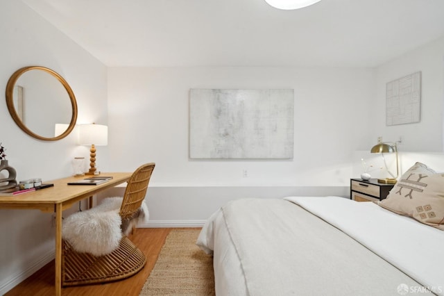 bedroom featuring light wood-style flooring and baseboards