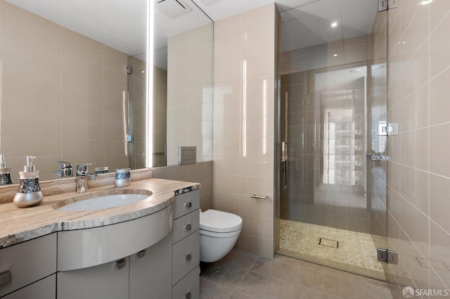 181 Fremont St Unit 55C, San Francisco, CA 94105 - bathroom featuring tile walls, vanity, a shower stall, and tile patterned flooring