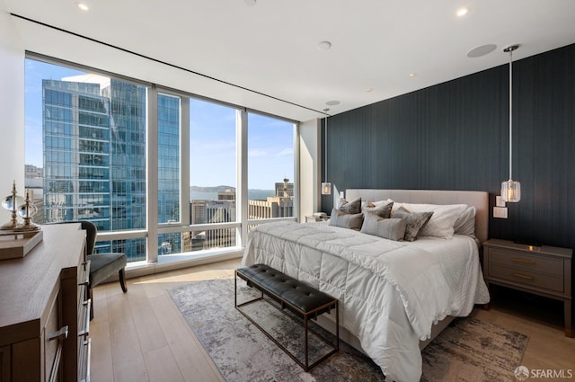 181 Fremont St Unit 55C, San Francisco, CA 94105 - bedroom with a wall of windows, wood finished floors, and a view of city