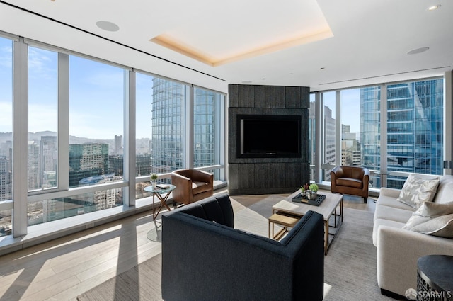 181 Fremont St Unit 55C, San Francisco, CA 94105 - living room featuring floor to ceiling windows, a tray ceiling, and wood finished floors
