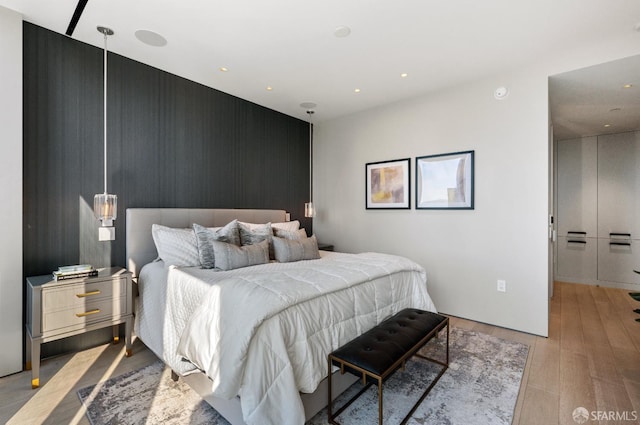 181 Fremont St Unit 55C, San Francisco, CA 94105 - bedroom featuring an accent wall, wood finished floors, and recessed lighting
