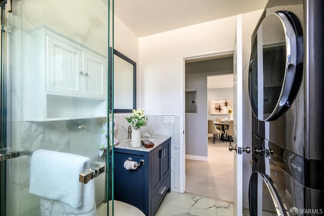 19652 Stanton Ave, Castro Valley, CA 94546 - full bathroom featuring stacked washer / dryer, marble look tile flooring, vanity, a shower stall, and electric panel
