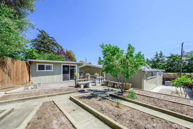 19652 Stanton Ave, Castro Valley, CA 94546 - rear view of house featuring a fenced backyard, a vegetable garden, a patio area, and an outbuilding