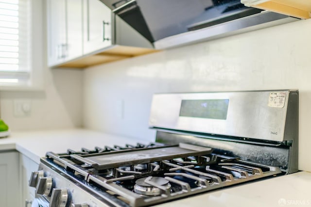 19652 Stanton Ave, Castro Valley, CA 94546 - kitchen view of stainless steel range with gas cooktop, white cabinetry, and light countertops